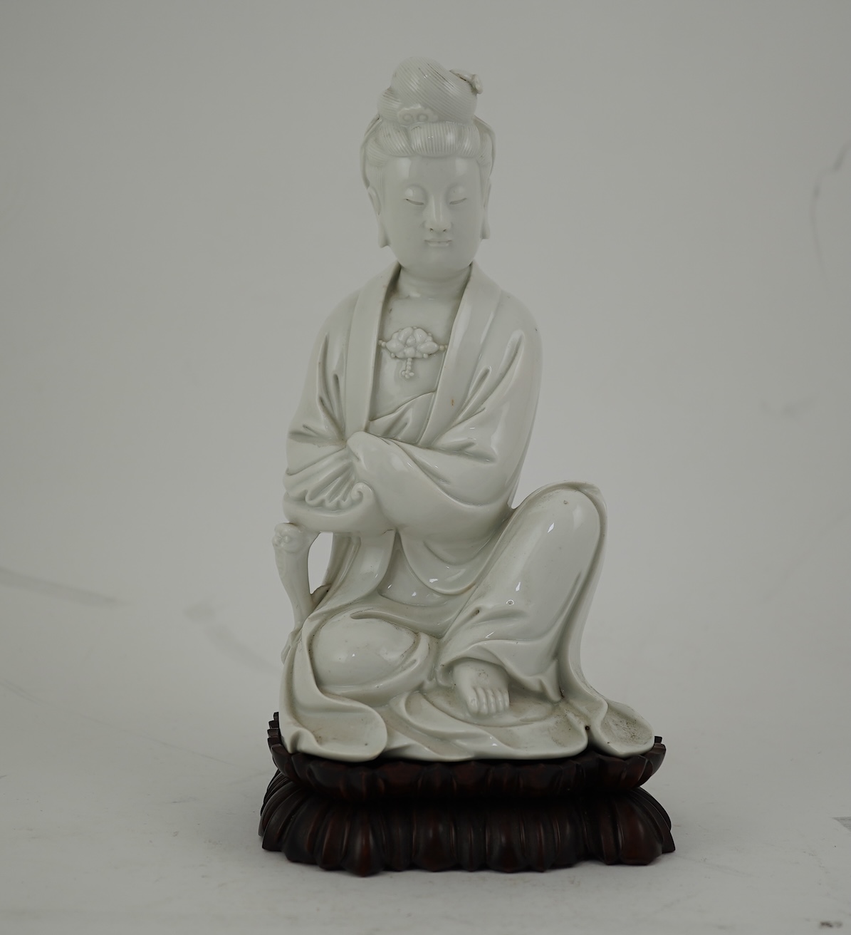 A Chinese blanc-de-chine seated figure of Guanyin, late 19th/early 20th century